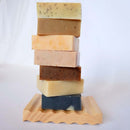 Stack of soap bars on wooden holder